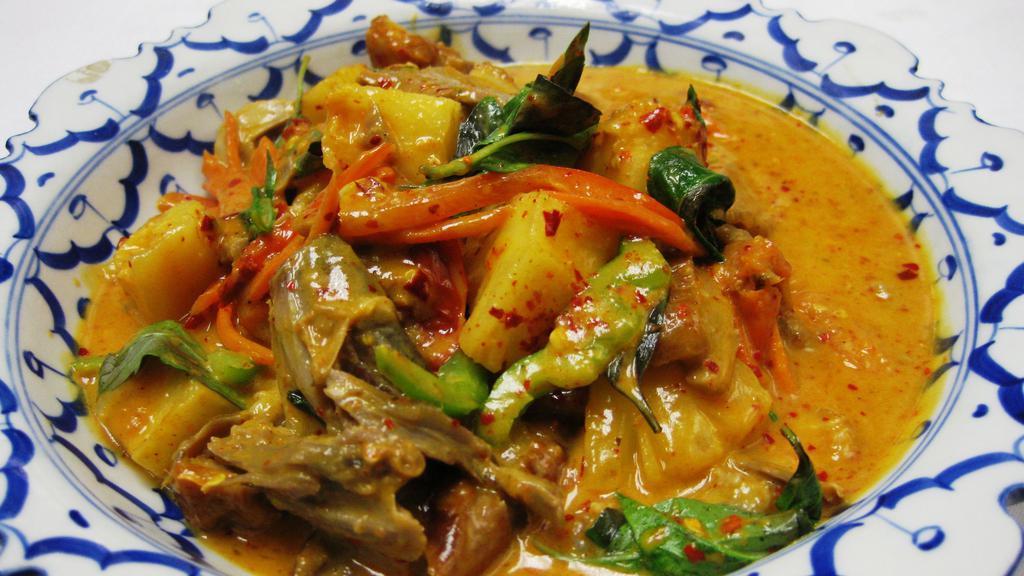Red Duck Curry · Spicy. Slices of boneless roasted duck simmered in red curry with coconut milk, pineapple, tomatoes and basil.