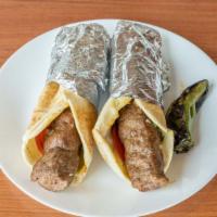 Beef Lule Kabob Sandwich · Kabob sandwich served with tomatoes, onions, parsley pickles wrapped in pita bread.