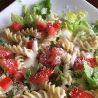 Fusilii Salad · Crispy romaine, lettuce, fusilli pasta, roma, tomatoes, garlic tortillas, croutons, and Parm...