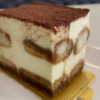 Tiramisu Cake Slice · Light vanilla sponge cake with coffee lady fingers and cocoa powder topping.