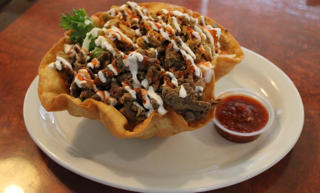 Lamb Discovery Taco Bowl · new. Lamb in Extra-large Taco bowl with rice, mix salad, cheese, and many other items. Extra meat for an additional charge. Add side French Fries for an additional charge. Make it value meal by adding Regular Drink and French Fries for an additional charge.