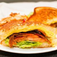 Breakfast Sandwich · Three eggs, bacon, sausage, ham or chorizo, lettuce, mayo and tomato, choice of cheese serve...