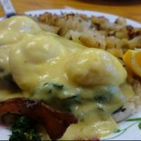 Eggs Florentine · Three poached eggs atop a grilled English muffin, bacon, grilled tomatoes, spinach and holla...