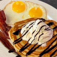2 Chocolate Chip Pancake Combo · Chocolate sauce & whipped cream drizzle over the pancakes. 2 sausage links or 2 slices of ba...