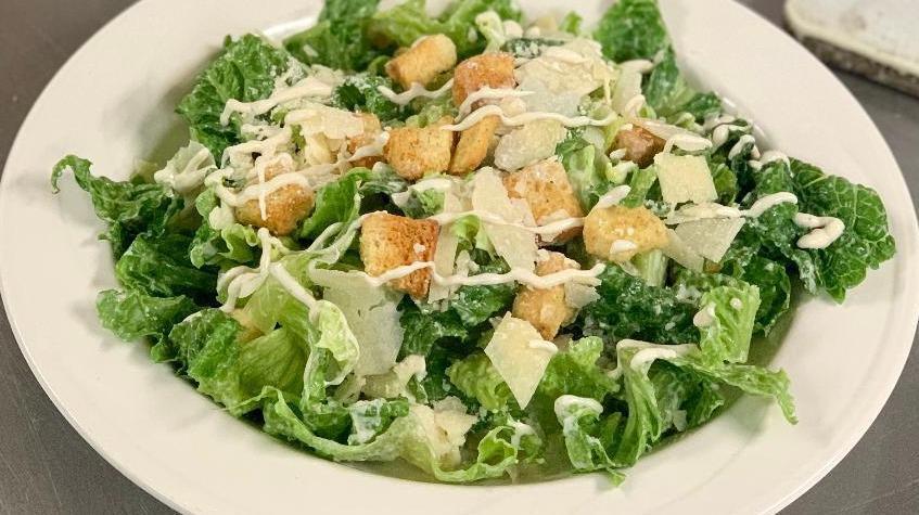 Caesar Salad · Romaine lettuce,croutons,shaved parmesan cheese.