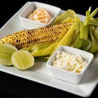 Grilled Corn On The Cob · Served with chili mayo, cotija cheese & lime.