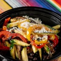 Tulum Bowl · A bowl with white rice, black beans, cotija cheese, shredded lettuce, and sauteed veggies.