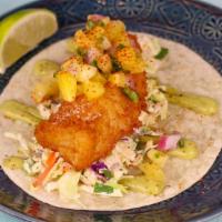 Baja Fish Taco · Beer battered cod, pineapple salsa, chipotle slaw, avocado cream - Served on a flour tortilla