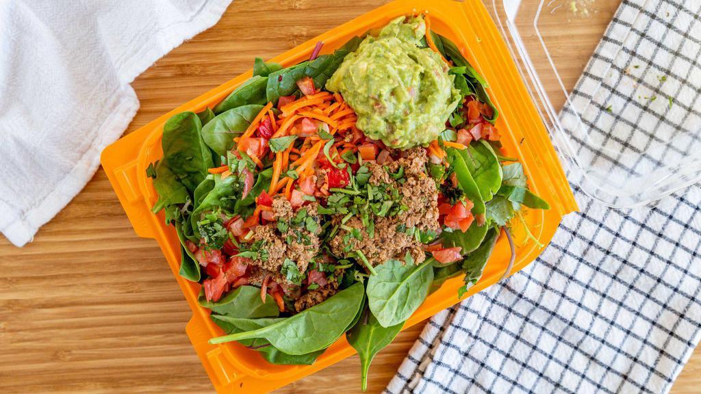 Fiesta Salad · Power greens, raw veggies, diced tomatoes, guacamole, taco 'meat,' and cilantro. Best served with chipotle sauce.