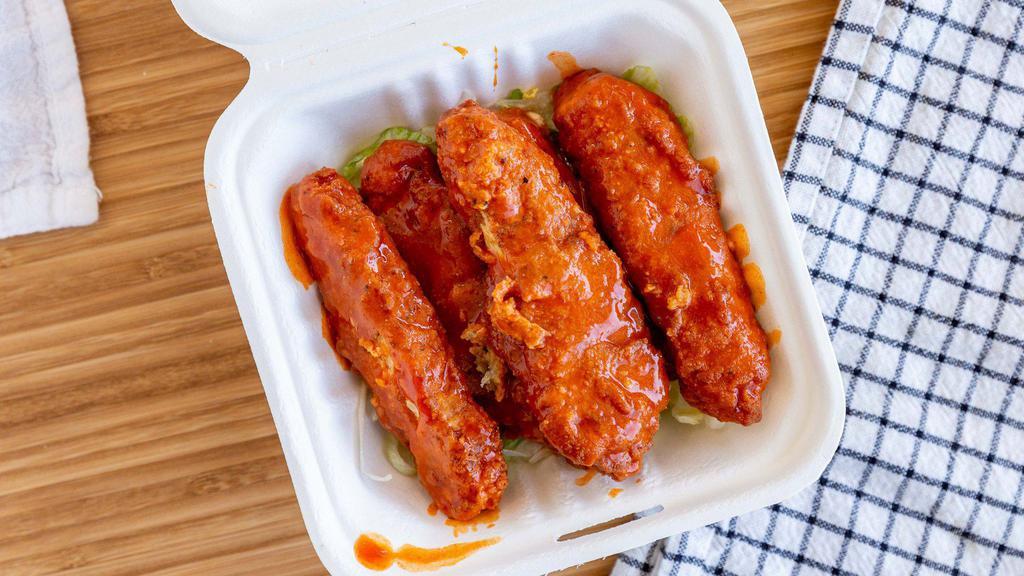 Buffalo 'Wings' · Five crispy 'chicken' tenders dipped in Buffalo sauce. Includes two sauces of your choice on the side.