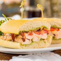 Grilled Chicken Melt Sandwich · Pesto, chicken breast, bacon, red onion, tomato and mozzarella cheese on a toasted French ro...
