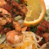 Ceviche Tostada · Flat crispy corn tortilla topped with shrimp, cooked with fresh lime juice. Mixed with tomat...