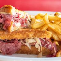 Corned Beef Reuben With Fries · thinly sliced corned beef with sauerkraut and melted swiss cheese on grilled marbled rye ser...