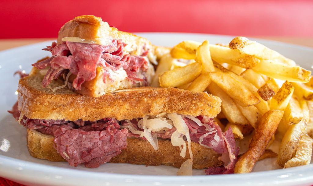 Corned Beef Reuben Sandwich · Lean corned beef covered with sauerkraut and melted Swiss cheese on grilled rye bread with Thousand island dressing on the side.
