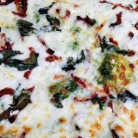 Pesto Pizza · Mozzarella cheese, pesto sauce, sun-dried tomatoes, fresh garlic, basil.