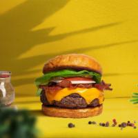 Vegan Bacon Burger · Seasoned plant-based patty topped with melted vegan cheese, layers of crispy vegan bacon, le...