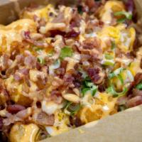 Loaded Tator Tots · Tator Tots loaded with melted cheese, bacon, and green onions.