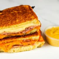 Smoked Ham & Three Cheese Melt · Smoked ham, Cheddar, Swiss, and Parmesan cheeses melted between buttery, toasted sourdough b...