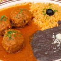 Albondigas En Chipotle · Meatballs filled with hardboiled eggs, cooked in our chipotle sauce. Served with rice, black...