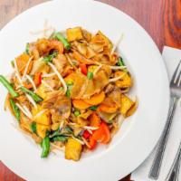 Spicy Noodles · Vegan.  Mild. Flat rice noodles tossed with brown onions, green beans, carrots, tomatoes, be...