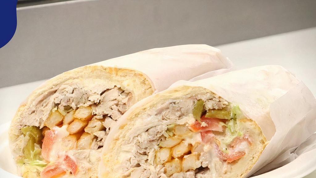 Chicken Sub Sandwich · Made on a 10-inch French Baguette with chicken, garlic spread, tomato, lettuce, pickles and fries.