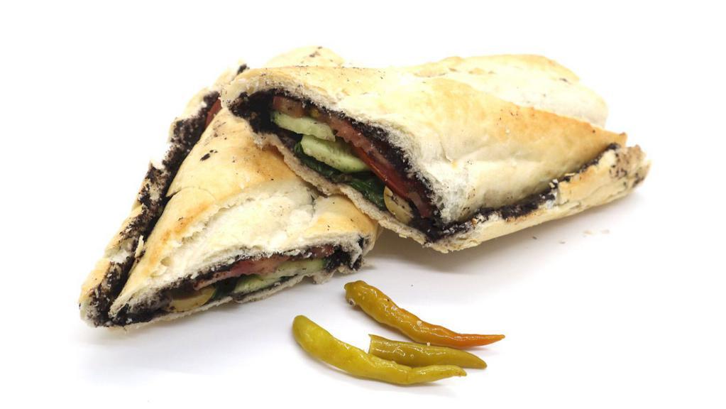 Olive Tapenade Sandwich · Made on a 10-inch French baguette with olive paste, tomatoes and cucumbers.