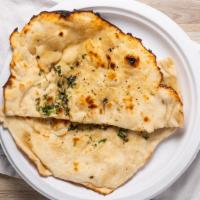 Garlic Naan · White wheat leavened bread stuffed with fresh garlic and herbs. Baked in tandoor.