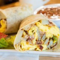 Breakfast Burrito · Eggs, homemade potatoes, cheese & choice of bacon, sausage, chorizo, or ham. Add steak for $...