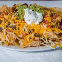 Super Nachos · Orn chips served with beans and melted cheese with your choice of meat, garnished with hot j...