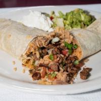 Carne Asada Burrito · With onion, cilantro, rice, and beans. Topped with guacamole and sour cream.