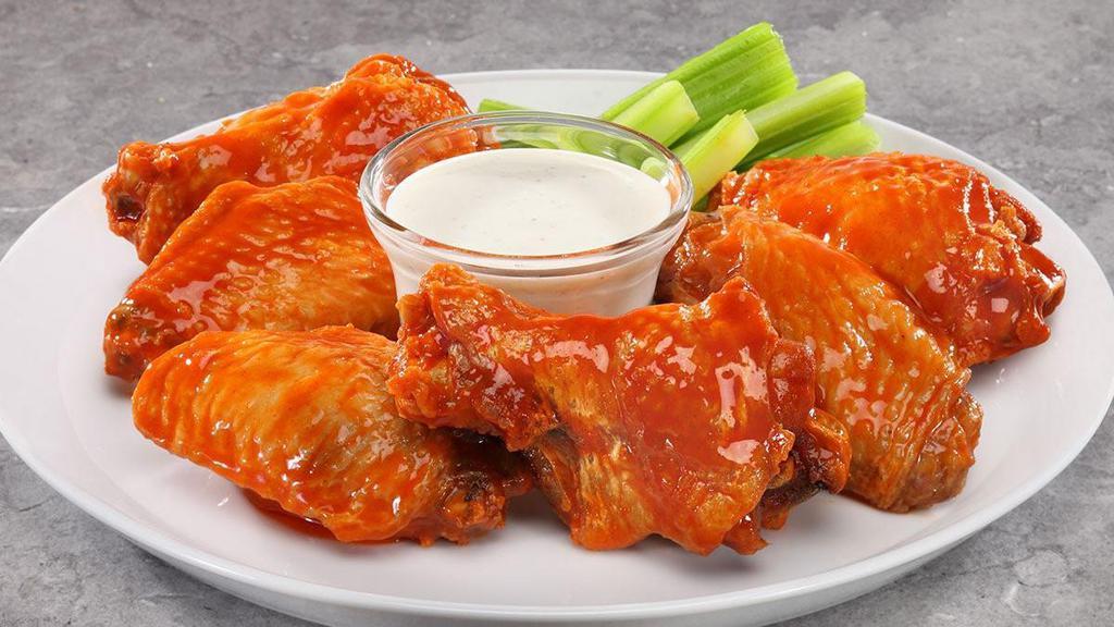Traditional Chicken Wings · A classic combination of finger-licking flats and drumettes, fried and coated in your choice of sauce.