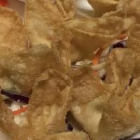 Crab Wontons · Six pieces. Golden-fried wontons filled with crab, cream cheese, and green onions. Served wi...