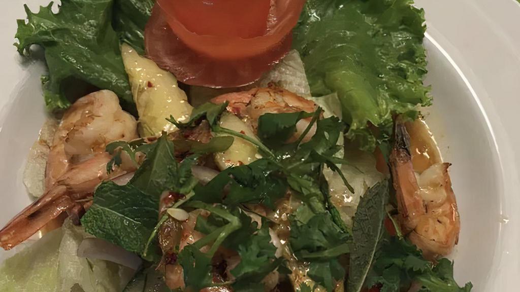 Papaya Salad · Fresh shredded green papaya, carrots, garlic, crushed peanuts, tomatoes, green beans, and shrimp served over a bed of salad greens. Tossed in honey lime dressing.