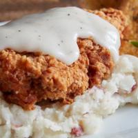 Fried Chicken · A classic comfort, hand breaded chicken breast, fried, and topped with rich country gravy, o...