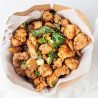 Popcorn Chicken · House marinated chicken bite size fried to golden with fried basil leaves and house seasonin...