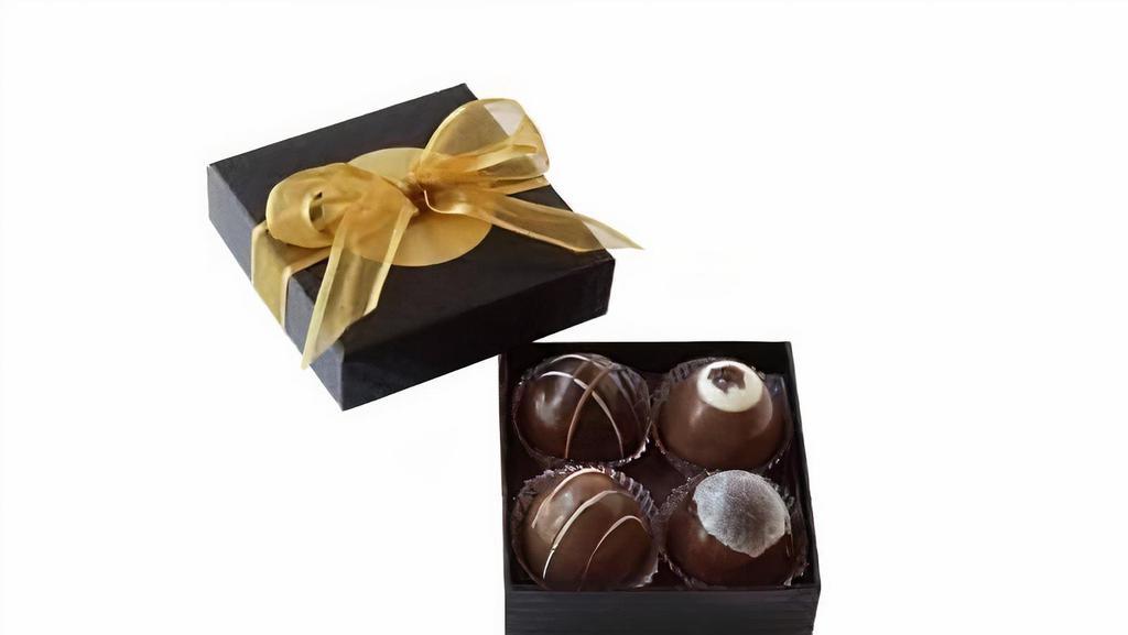 4 Piece Chocolate Truffle Box · Our signature product, the chocolate truffle, wraps creamy French-inspired ganache with dark, milk, and white belgian couverture chocolate. Each individual truffle is artistically hand-topped which makes each truffle uniquely special. Truffles come in our standard black box with a ribbon which changes seasonally.