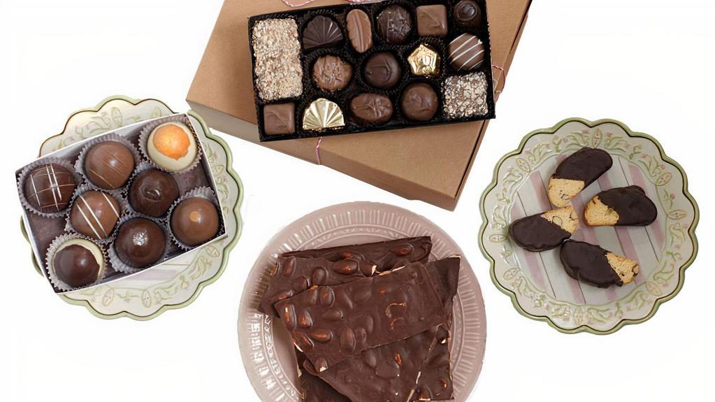 The Giver Box · Box includes: ½ lb. assorted chocolate traditional box, eight-piece assorted grand chocolate truffle box, 
1 lb. Dark belgian chocolate salted almond bark, and four-dark belgian chocolate dipped Italian biscotti.