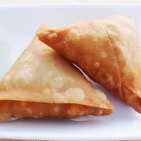 Samosa · Two traditional crispy fried pastry stuffed with spices, potatoes and peas.