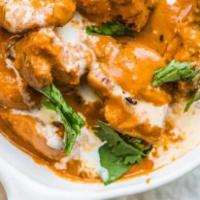 Butter Chicken · Tender chicken pieces marinated in yogurt and simmered in a rich tomatoe based sauce with ca...