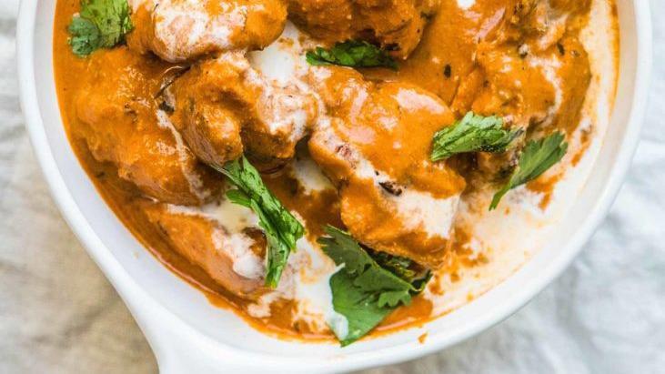 Butter Chicken · Tender chicken pieces marinated in yogurt and simmered in a rich tomatoe based sauce with cashews and butter