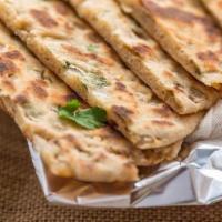Onion Kulcha · Housemade naan filled with diced onions, herbs and spices.