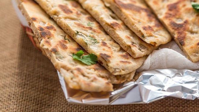 Onion Kulcha · Housemade naan filled with diced onions, herbs and spices.