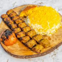 Ground Beef Kabob (Koobideh) Plate · Two skewer of marinated ground beef with grilled tomatoes and vegetables.