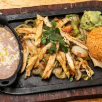 Pollo Fajitas · Chicken strips. Served with grilled bell peppers, tomato and onions, with a side of guacamol...