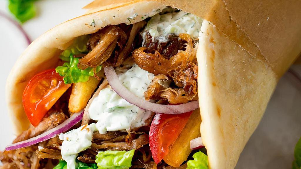 Pork Gyro And Fries · PORK GYRO: SEASONED PULL A PART PORK WITH TZATSIKI SAUCE, LETTUCE, TOMATO AND ONIONS.