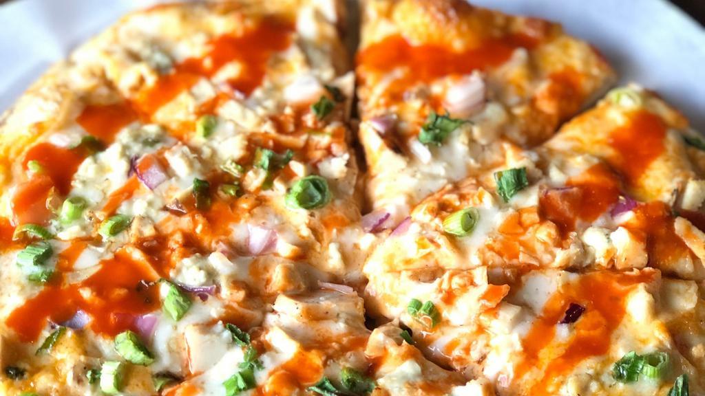 Buffalo Chicken Pizza · Buffalo Ranch Sauce, Mozzarella, Blue Cheese, Chicken, Red Onions, Green Onions and a drizzle of Buffalo Sauce.