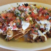 Martha'S Nachos · Our home made yellow, red, and green chips with your choice of meat. Topped off with refried...