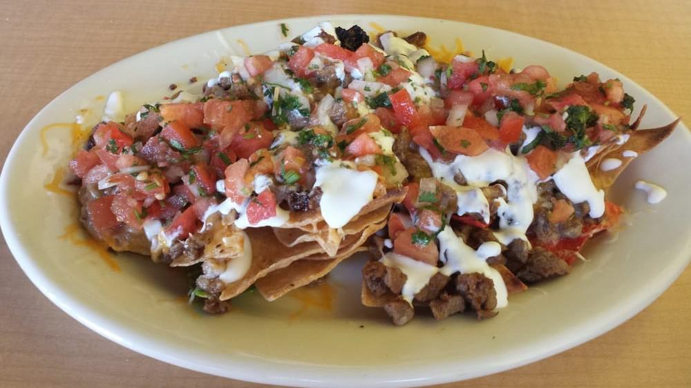 Martha'S Nachos · Our home made yellow, red, and green chips with your choice of meat. Topped off with refried beans, cheese, sour cream, guacamole and pico de gallo.