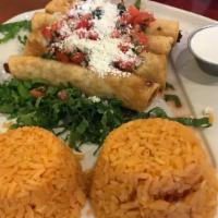 Chicken Flautas · 4 rolled crispy tacos topped with lettuce, sour cream, pico de gallo, guacamole and cotija c...