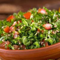 Tabouleh · Chopped parsley , tomatoes, onions with cracked wheat drizzled with lemon juice and olive oil.